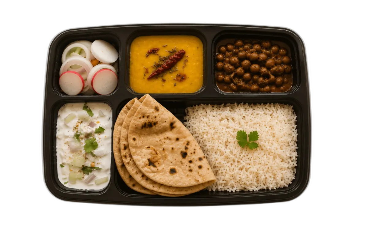 Home-cooked tiffin — rice, chole, dal, salad and fresh roti