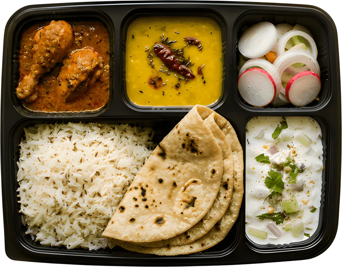 Non-Veg Thali — dal, chicken or egg curry, roti, rice, salad and raita